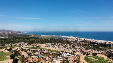 LOS CABOS MEXICO-2019: Flying Over Buildings Homes Roads And Fields Towards The