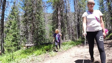 WINTER PARK COLORADO-2019: Woman and Little Girl Walk Through Green Forest