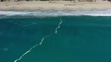 LOS CABOS MEXICO-2020: Sea Green Ocean Waves Zooming Toward Sandy Beach