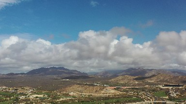 LOS CABOS MEXICO-2020: White Cumulus Clouds Sprinkled Across Blue Sky Above