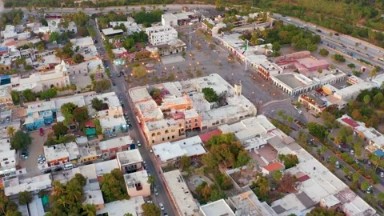 SAN JOSE DEL CABO MEXICO-2021: Multiple Blue Buildings On A Road With Green Trees