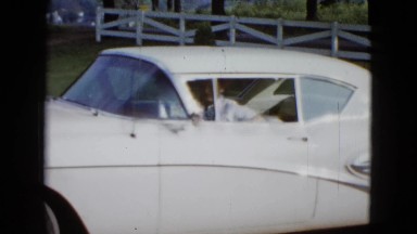 1958: Las Vegas Usa. A Dog Sitting In The Driver's Seat Of A White Car.