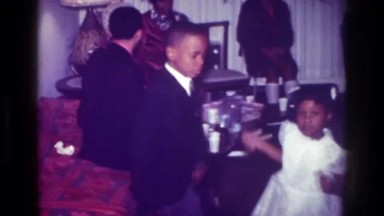 1976: Harlem New York Usa. A Couple Of People Standing Next To Each Other.