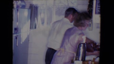 1961: Salton Sea California. A Man And Woman Preparing Food In A Kitchen.