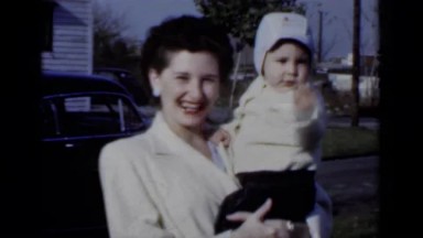 1950: New York. A Woman Holding A Baby In Her Arms.