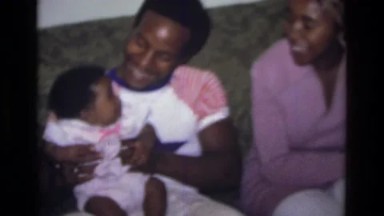 1975: Atlanta Georgia, USA. A Man Sitting On A Couch Holding A Baby.