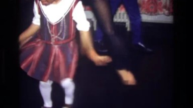 1975: Bronx, New York, USA. A Little Girl In A Red And Purple Dress.