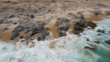 BUZZARDS BEACH EAST CAPE BCS MEXICO-2023: Aerial View Of A Beach With Rocks