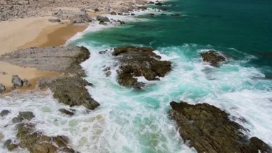 BUZZARDS BEACH EAST CAPE BCS MEXICO-2023: A Large Body Of Water Next To A Sandy Shoreline
