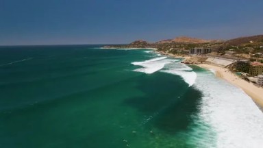 COSTA AZUL BEACH LOS CABOS BCS MEXICO-2023: A Large Body of Water Next to a Sandy Shoreline