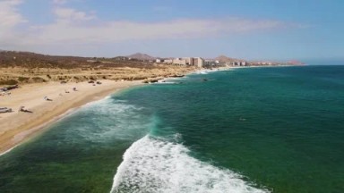 EL TULE BEACH LOS CABOS BCS MEXICO-2023: A Calm Body of Water Next to a Sandy Beach