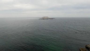 BAHIA ASCUNCION BCS MEXICO-2023: Small Boat Out On The Water Near A Rocky Shore