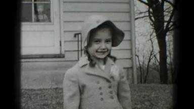 1946: Harrisburg, PA. USA. Young girl wearing a hat and coat smiling