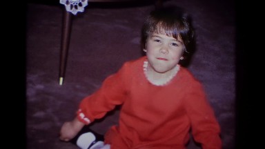 1966: Young Girl in Red Shirt Smiling at Camera