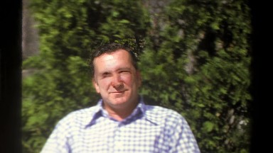 1969: Man Sitting in Chair Outside