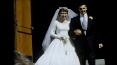 1962: Camden, New Jersey. USA. Bride and groom walking down the aisle of a