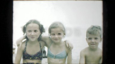 1947: Connecticut, USA. Three children standing together in the water