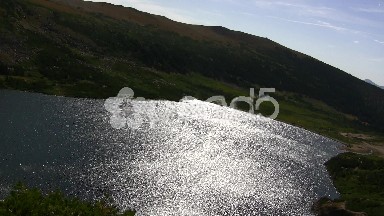 Sun Reflection on Alpine Glacier Lake