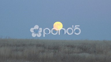 Zoom In On Moon Rise At Sunset