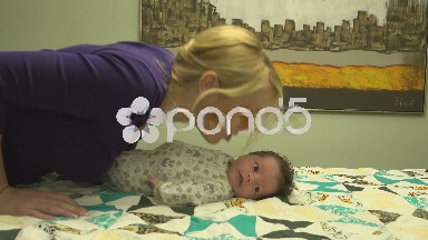 Mother Kissing Newborn Baby