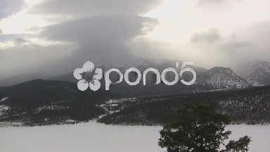 (timelapse) Snowy Mountain Range Covered in Fog