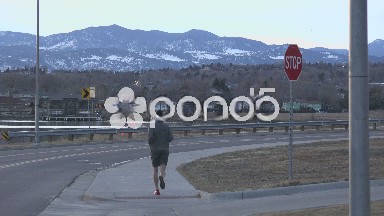 Man Jogging On Dust Car Drive