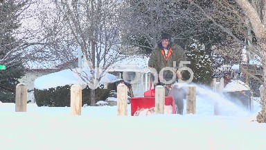 Man Snowblowing The Sidewalk