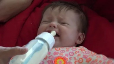 WESTMINSTER, COLORADO, UNITED STATES-2015: Baby Cries for Bottle, Gets It