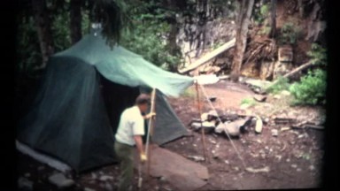 (1960's 8mm Vintage) Man Setting Up a Old Camping Tent