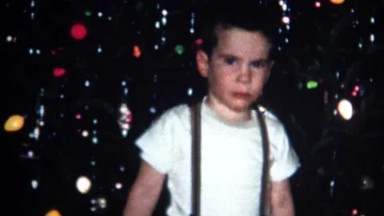 (8mm Vintage) Kid Showing Off Christmas Tree and Gifts 1957
