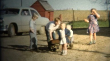 (8mm Vintage) 1952 Farm Kids Pulling Wagon. Iowa, USA.