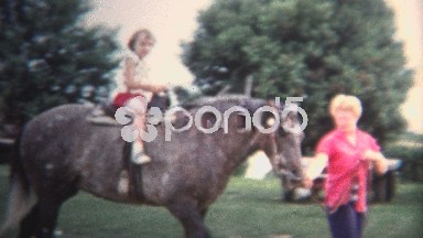 (8mm Vintage) 1954 Girls Riding Horse For 1st Time. Iowa, USA.