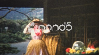 (8mm Vintage) 1955 Woman Tries On Hawaiian Hula Dancer Outfit