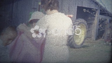 Arkansas, USA - 1965: Mom Dressing Kids in City Clothes at the Farm.