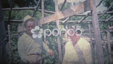 Arkansas, USA - 1965: Farmer and Wife Give Summer Garden Tour