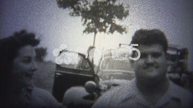 Oklahoma, USA - 1943: Man and Woman Celebrate New Car in Vintage 8mm Footage