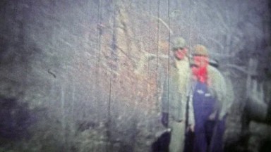 TENNESSEE, USA - 1952: Deer Hunters Clean and Skin the Kill in the Forest.