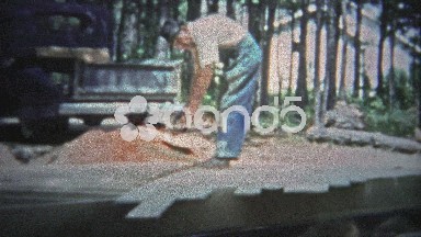 Tennessee, USA - 1953: Man Laying Wood Sub-Flooring in House Construction