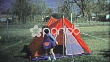 Boulder, CO. USA - 1974: Girl Scout Testing Camping Tent for Outdoor Activity