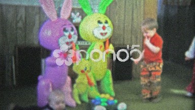 BOULDER, CO. USA - 1974: Boy attacks Easter egg candy and eats the chocolate.