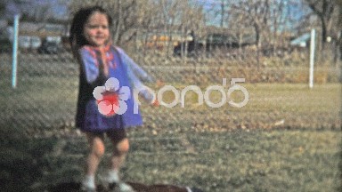 BOULDER, CO. USA - 1974: Girl practicing her jumping on small inflatable