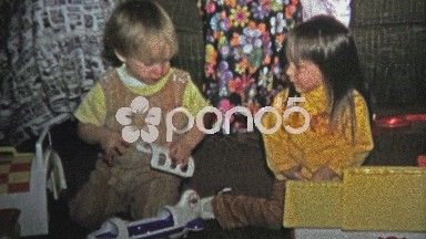 1973: Brother mad at sister for grabbing at his new Christmas toy.