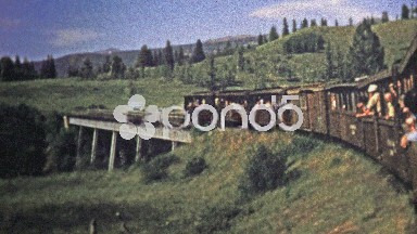 1972: Train cross a bridge and pov from inside coal powered engine.
