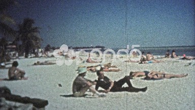 1972: Peeping tom at the beach zooms in on pretty women.