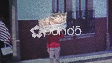 1974: Local townspeople carrying things on their heads.