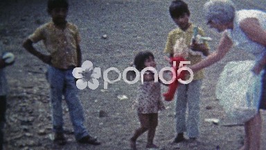 1974: Old Woman Giving Poor Child a Doll in Mexico City