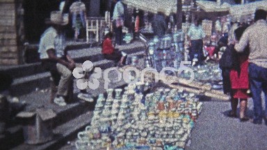 1974: Marketplace of live chickens, baskets, caged exotic parakeet bird.