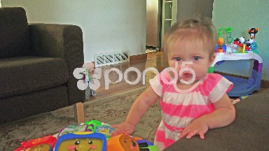 Closeup cute baby standing and smiling living room.