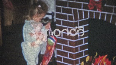Boulder, Colorado (1951): Girl opens Christmas stocking gets candy out.