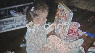 Boulder, Colorado (1951): Girl opening Christmas gift coloring book and other.